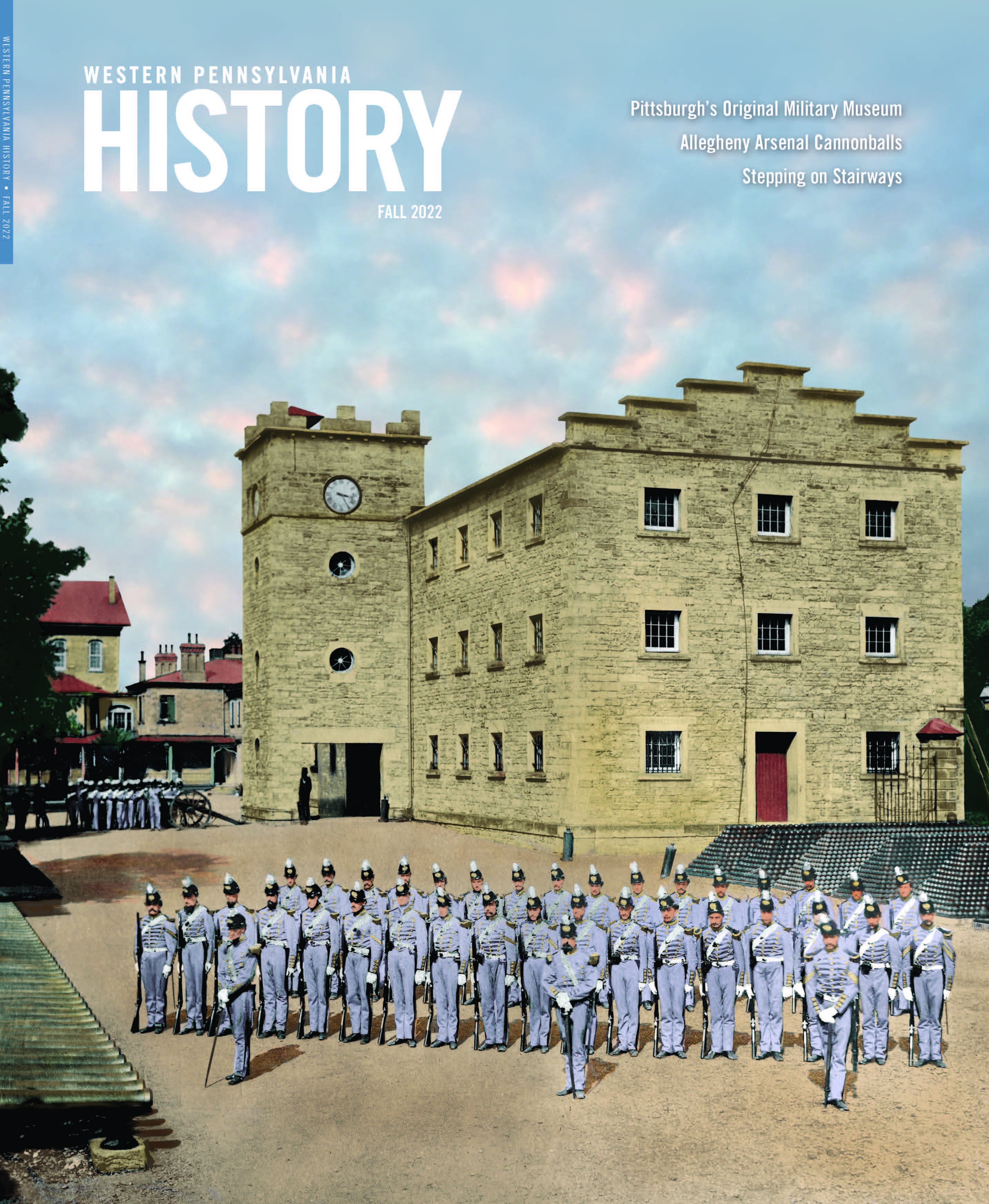 Magazine cover with photo of a group of uniformed men standing amid piles of cannonballs outside a stone building.